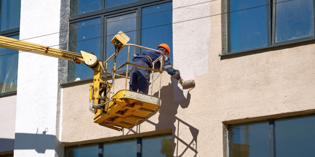 Tenant improvement contractor paints side of commercial office building