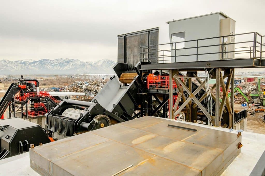 Metro Recycling's processing facility with heavy-duty machinery, elevated platforms, and a control room structure.