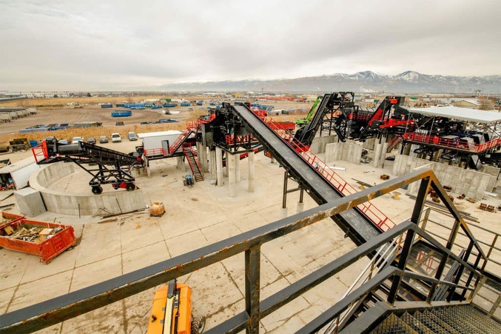 Aerial view of Metro Recycling's processing facility under construction, featuring conveyor systems and platforms.