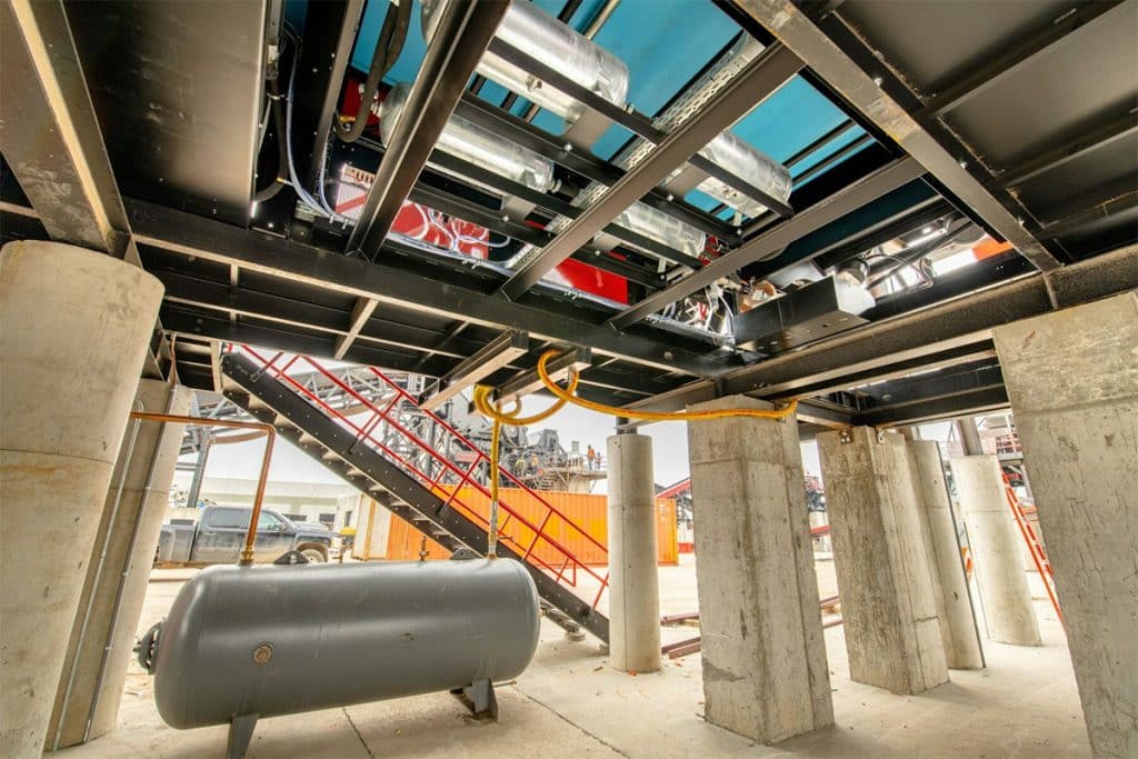 Metro Recycling's processing plant under construction, showing conveyor systems, steel framing, and support columns.
