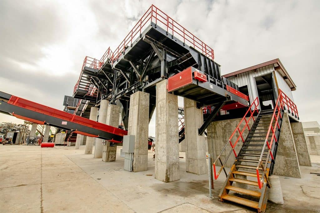 Metro Recycling's processing facility with elevated conveyors, concrete supports, steel staircases, and safety railings - Cook Builders industrial construction project